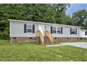 Charming single-story home with gray siding, brick foundation, and a well-manicured lawn at 332 Eastfield Dr, Rocky Mount, NC 27801
