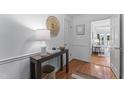 Bright foyer with hardwood floors, white trim, and a view into the living area at 3911 Hope Valley Rd, Durham, NC 27707