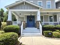 Charming home entrance featuring a blue door with a wreath and a welcoming front porch with white railings at 4562 Brighton Ridge Dr, Apex, NC 27539
