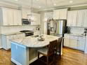 Modern kitchen featuring granite countertops, stainless steel appliances, and an island with seating at 4562 Brighton Ridge Dr, Apex, NC 27539