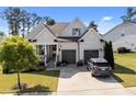 Beautiful home with a three-car garage, manicured lawn, and inviting curb appeal at 461 Cedar Pond Ct, Knightdale, NC 27545