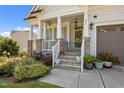 Inviting front porch with stone accents, a decorative wreath, and a charming entrance at 461 Cedar Pond Ct, Knightdale, NC 27545