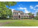 Traditional brick home with dormers, situated on a large lot with mature trees and well-maintained lawn at 4620 Gomar Ln, Fuquay Varina, NC 27526