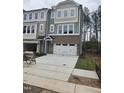 Charming townhouse featuring a garage, multiple windows, and neutral-colored siding with brick accents at 5028 Jowetts Walk Dr # 24, Cary, NC 27519