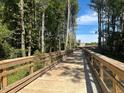 Wooden walking bridge in a wooded area on a sunny day at 5028 Jowetts Walk Dr # 24, Cary, NC 27519