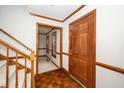 Bright foyer with beautiful parquet floors, white walls, and wooden trim and staircase at 5800 Heatherbrook Cir, Raleigh, NC 27612