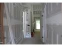 Hallway showing architectural trim work leading to a sunlit area at 5900 Tranquil Cv, Youngsville, NC 27596