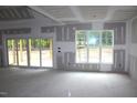 Bright living room featuring a sliding glass door and a large window at 5900 Tranquil Cv, Youngsville, NC 27596