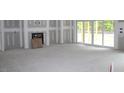 Spacious living room featuring sliding glass door and a cozy fireplace at 5900 Tranquil Cv, Youngsville, NC 27596