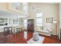 Bright living room features hardwood floors, soaring ceilings, large windows, and open layout perfect for entertaining at 6 Newgate Ct, Durham, NC 27713