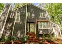 Close-up of the home's entry showing the front door, brick steps, and well-maintained landscaping at 6035 Sentinel Dr, Raleigh, NC 27609