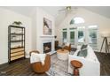 Inviting living room with vaulted ceilings, fireplace, and abundant natural light from the large windows and french doors at 6737 Vernie Dr, Raleigh, NC 27603