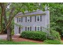 Two-story home with gray siding, mature landscaping and a welcoming front entrance at 7 Hitching Rack Ct, Durham, NC 27713