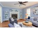 Inviting living room with a cozy fireplace, ceiling fan and hardwood floors at 7 Hitching Rack Ct, Durham, NC 27713