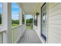 Side porch area with wood flooring and charming architectural details at 750 Raymond Dr, Clayton, NC 27527