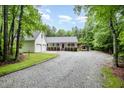 Charming home featuring a large front yard, a detached two-car garage, and an attached carport at 7603 Nichols Dr, Rougemont, NC 27572