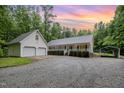 Charming home featuring a large front yard, a detached two-car garage, and an attached carport at 7603 Nichols Dr, Rougemont, NC 27572
