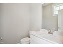 Neutral powder room featuring a modern vanity with quartz countertop and a sleek toilet at 7719 Barefoot Rd, Fuquay Varina, NC 27526