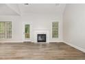 Bright living room featuring wood flooring, a fireplace, and natural light at 7936 Milltrace, Raleigh, NC 27615