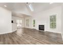 Bright living room featuring wood flooring, a fireplace, and natural light at 7936 Milltrace, Raleigh, NC 27615
