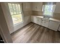 Bright kitchen featuring durable laminate flooring, ample countertop space, and natural light, ready for customization at 0 Chapel Hill Rd, Durham, NC 27707