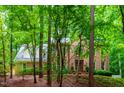 Beautiful brick home surrounded by mature trees, offering a serene and private setting at 101 Collinson Dr, Chapel Hill, NC 27514