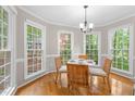 Bright breakfast nook surrounded by large windows with views of the lush backyard at 106 Ridgepath Way, Cary, NC 27511