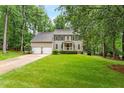 Traditional two-story home with a well-manicured lawn, two-car garage, and inviting front porch at 106 Ridgepath Way, Cary, NC 27511