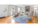 Bright home office with natural light, neutral walls, light blue rug, and hardwood floors at 106 Ridgepath Way, Cary, NC 27511