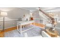 Spacious home office with desk, chairs, hardwood floors, and access to staircase at 106 Ridgepath Way, Cary, NC 27511