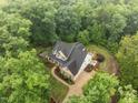 Stunning aerial view of the private estate, showcasing lush landscaping, hardscape and mature trees at 109 Henrys Ridge Rd, Pittsboro, NC 27312