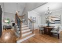 Elegant entryway with staircase, hardwood floors, and seamless transition to the dining and living areas at 109 Henrys Ridge Rd, Pittsboro, NC 27312