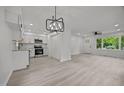 Bright living space featuring an open layout, modern chandelier, and wood-look flooring at 111 S Gaylee Lake Dr, Wendell, NC 27591