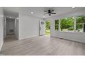Inviting living area with an open door, ceiling fan, and large window views at 111 S Gaylee Lake Dr, Wendell, NC 27591
