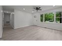 Bright living area with an open door, ceiling fan, and large window views at 111 S Gaylee Lake Dr, Wendell, NC 27591
