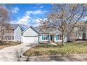 Inviting one-story home boasts light blue siding, well-kept lawn, attached garage, and blue shutters at 11113 N Radner Way, Raleigh, NC 27613