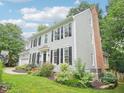 Exterior view of a two-story home with a brick chimney and lovely landscaped yard at 113 Bergeron Way, Cary, NC 27519
