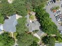 A birds-eye view of a landscaped home with a fire pit, along with its parking lot and neighboring homes at 1300 Heritage Club Ave, Wake Forest, NC 27587