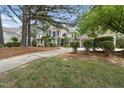 Traditional home featuring landscaped yard, detached garage, and inviting front entrance at 1300 Heritage Club Ave, Wake Forest, NC 27587