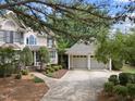 Well-maintained two-story home and detached two-car garage on manicured lot at 1300 Heritage Club Ave, Wake Forest, NC 27587