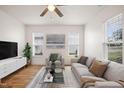 Bright living room features wood floors, neutral walls and natural light from many windows at 1506 Golden Bell Dr, Raleigh, NC 27610