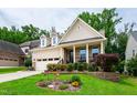 Beautifully landscaped front yard of this charming two-story home at 1577 Tice Hurst Ln, Apex, NC 27502