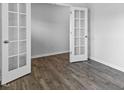 Room featuring hardwood floors, fresh paint, white trim and french doors at 191 Ethel Ln, Angier, NC 27501