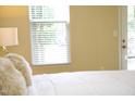 Bright bedroom shows a comfortable bed with plush pillows and natural light coming through large windows at 1912 Parkside Village Dr, Clayton, NC 27520