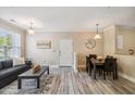 Charming living room and dining area with wood-look floors and neutral color scheme at 1912 Parkside Village Dr, Clayton, NC 27520