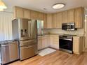 Modern kitchen featuring stainless steel appliances and abundant counter space for cooking convenience at 210 Crest Rd, Henderson, NC 27536