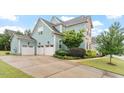 Charming home featuring a spacious driveway leading to a three-car garage, complemented by manicured landscaping at 212 Preatonwood Dr, Apex, NC 27539