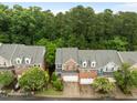 Aerial view of townhomes showing landscaping, garages, and proximity to trees at 238 Langford Valley Way, Cary, NC 27513