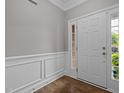 Welcoming entryway featuring wainscoting, hardwood floors, and a view of the front door and sidelight at 238 Langford Valley Way, Cary, NC 27513