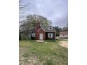 Charming two-story home featuring a brick chimney, dormer window and classic green window shutters at 2507 Chapel Hill Rd, Durham, NC 27707